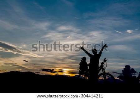 Mother and daughter with bike at twilight time