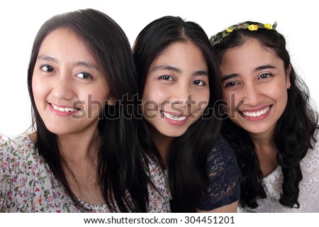 Close up self shot face portrait of three cheerful Asian girls, isolated on white background