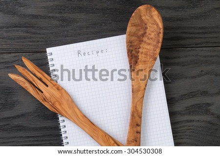 simple blank notepad with word recipe on rustic wood table, kitchen background