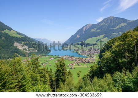 Beautiful landscape panorama by the lake with mountains in the background. Photograph was taken at a mountain pass in Switzerland in Swiss Alps.