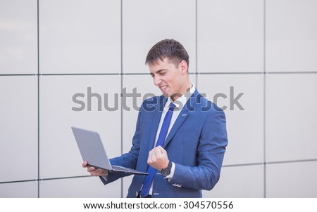 young business man think look up hold tablet pc computer, in bright blue office