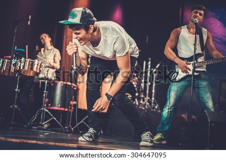 Music band performing on a stage  Royalty-Free Stock Photo #304647095