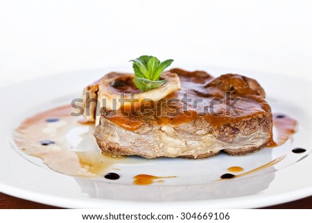 Gourmet thick juicy fillet steak medallion grilled to perfection and served topped with vegetable sauce