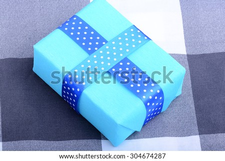 blue gift box with white ribbon