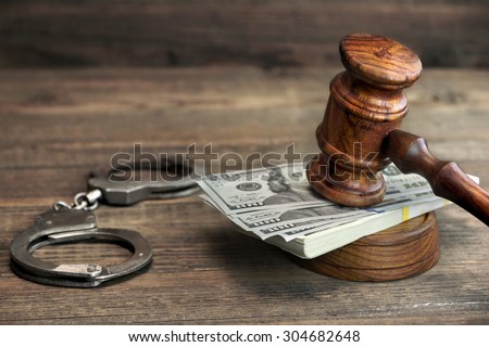 USA Dollar Money Cash, Real Handcuffs And Judge Gavel On Rough Wood Background. Concept For Arrest, Corruption, Bail, Crime, Bribing or Fraud. Royalty-Free Stock Photo #304682648