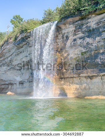 Spray Falls rainbow at Pictured Rocks National Lakeshore, near Munising, Michigan. Mineral seepage creates the colors: Red and orange are iron, green and blue are copper, black is manganese. 