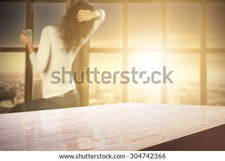 blurred background of big window with city landscape and room with desk 