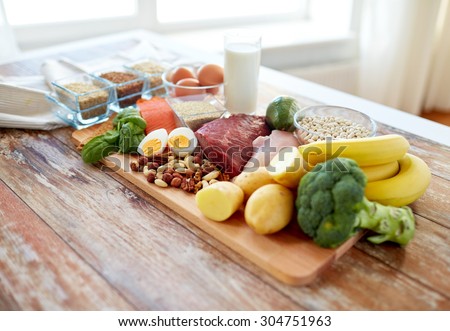 balanced diet, cooking, culinary and food concept - close up of vegetables, fruit and meat on wooden table Royalty-Free Stock Photo #304751963