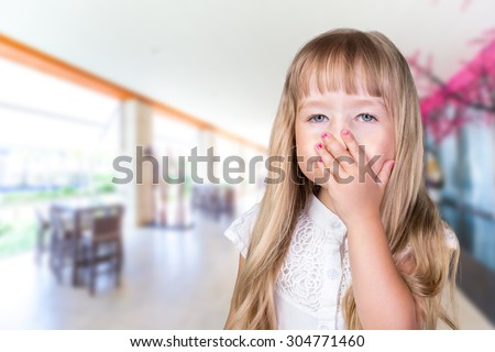 Little girl closing nose because of bad smell