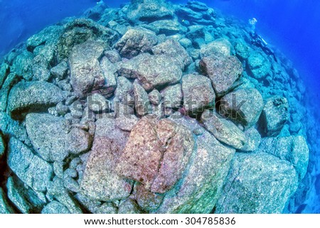 diver in underwater landscape without fishes and corals