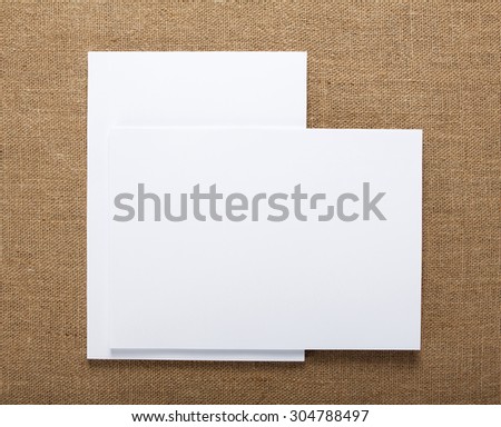 Blank flyer poster on burlap background to replace your design