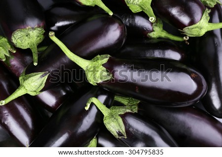 Heap of fresh eggplants close up Royalty-Free Stock Photo #304795835