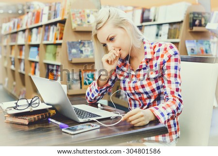 Beautiful girl studying in library 
