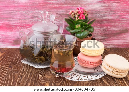 exotic green tea with flowers in glass teapot