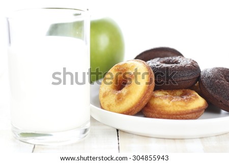 donut cake and chocolate donut cake with milk and apples for breakfast on wooden white background. donut, milk and apples. morning breakfast.