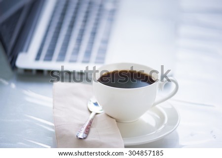 Coffee cup and laptop for business in coffee shop