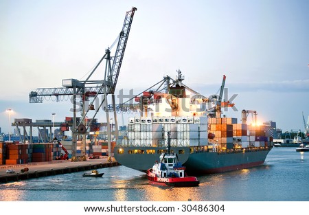 Ah huge container ship being maneuvered and reversed towards shore by pilots and tugboats Royalty-Free Stock Photo #30486304