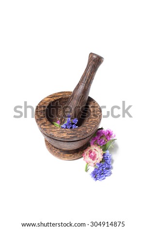Wooden brown sandalwood pounder flowers isolated on white. Good for spa salon, banners, sites, homemade cosmetics, brochures, advertising, etc