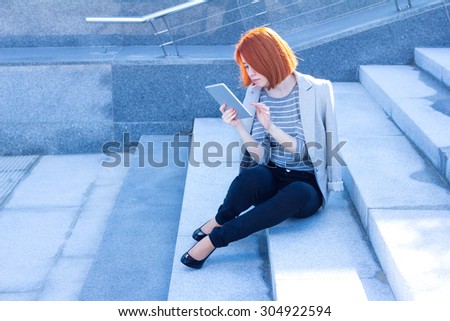 Business woman reading carefully tablet