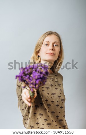 Girl with wild flowers in hands