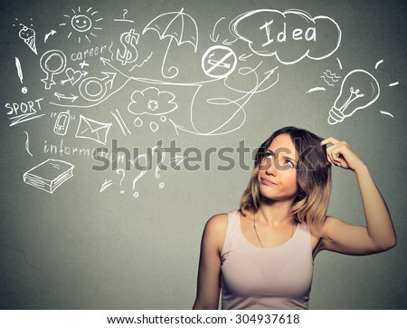 Portrait puzzled young woman thinking scratching head has many ideas looking up isolated gray wall background. Human face expression emotion feeling life perception. Decision making process concept