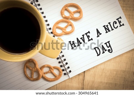 Cup of coffee and cookies on the table. Wishing a nice day.