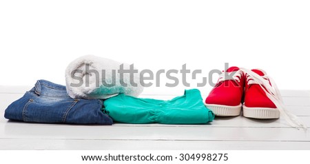 Red shoes and clothes on a white table