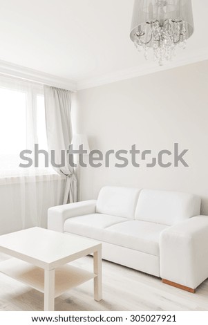 Picture of small table and sofa in simply furnished lounge