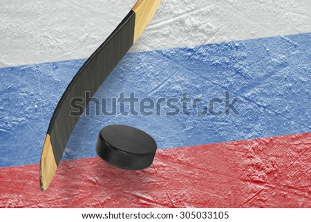 Hockey puck, stick and a fragment of an image of the Russian flag