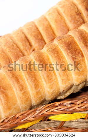 Puff pastry with a hot dog in a wicker basket.