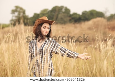 smiling Beautiful Asian Girl in the reed prairie