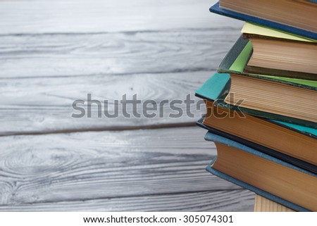 Stack of books on wooden table. Back to school. Copy space
