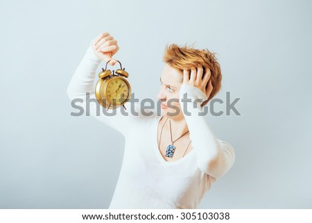 Young woman with alarmclock 