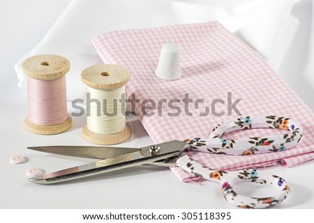 Fabric and sewing tools in pink Royalty-Free Stock Photo #305118395