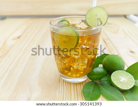 lemon ice tea on brown wooden table with lemons