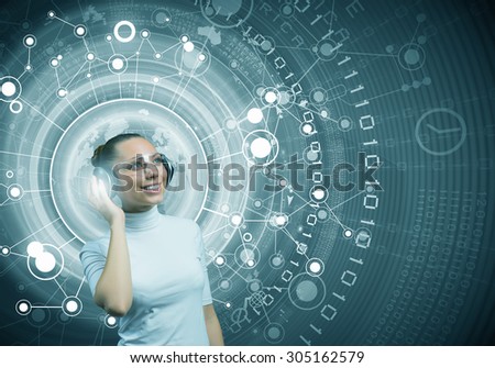 Young woman wearing headphones on digital blue background