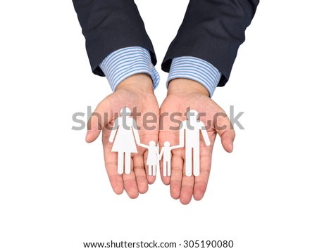 people, charity and care concept - close up of businessman hands holding paper family. isolated on white background with clipping path