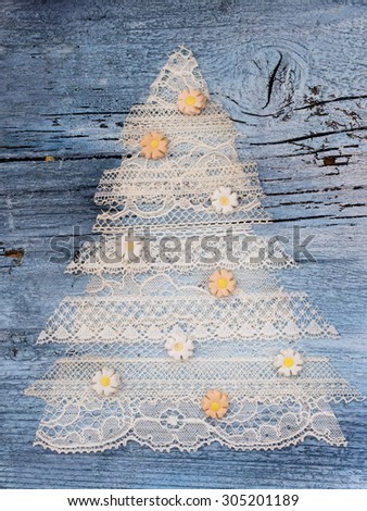 beautiful Xmas Tree made of delicate lace with decoration on the wooden background