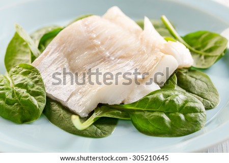 fish fillet on spinach leafs