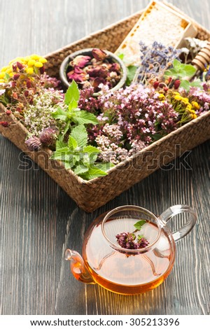 Dried and fresh herbs and flowers and herbal tea in teapot. Herbal medicine