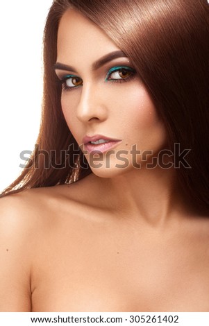 Vertical portrait of cutie lady with nice makeup and straight brown hairstyle in studio