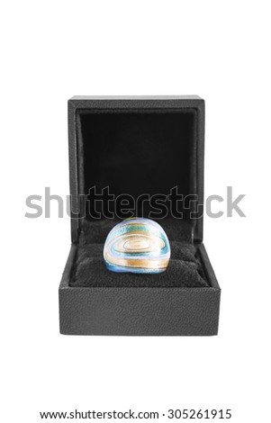 Enamelled ring in black jewel box on white background