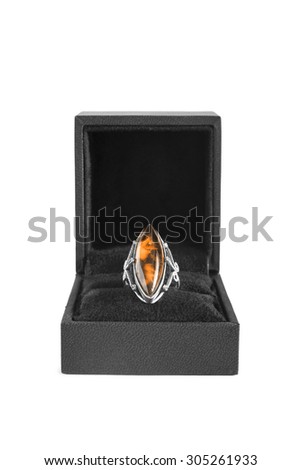 Vintage amber ring in black box on white background