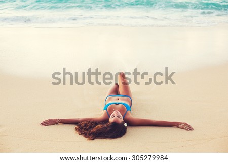 Summer Lifestyle, Beautiful Happy Carefree Young Woman Relaxing on the Beach at Sunset