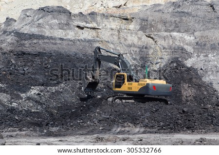 yellow backhoe work in coalmine Royalty-Free Stock Photo #305332766