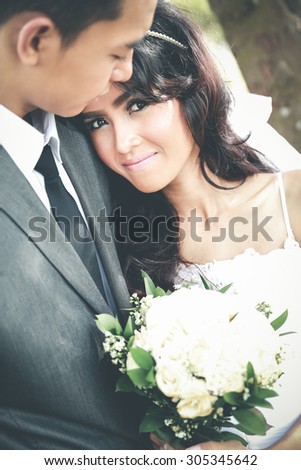close up portrait of beautiful bride smiling while lean on her groom shoulder