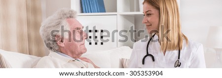 Young doctor is visiting old and sick man