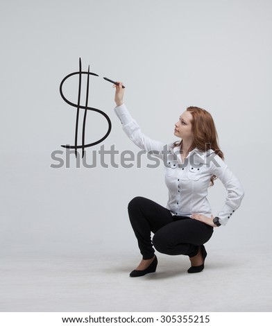 Young woman drawing dollar symbol on grey background