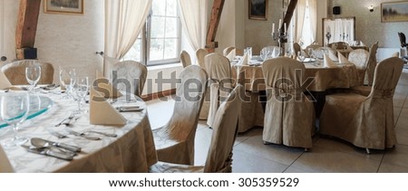 Picture of tables in restaurant prepared for reception