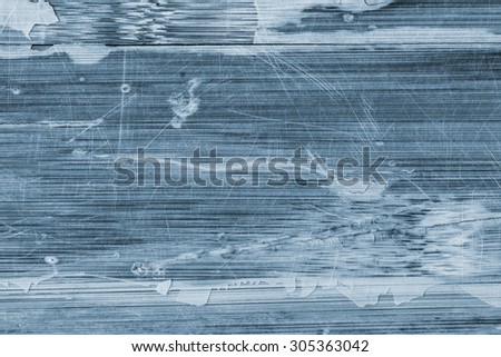 Photograph of Blue stained, old, weathered, varnished wooden laminated panel, cracked, scratched grunge texture.